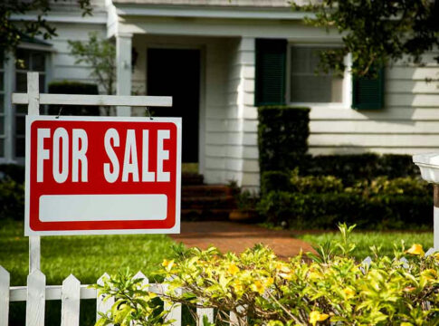 House with a For Sale sign in front.