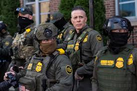 A group of law enforcement officers in tactical gear standing together