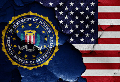 FBI seal overlapping American flag patches.