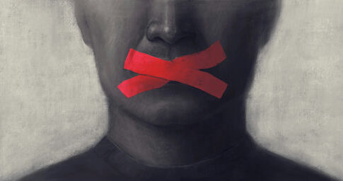 Portrait of a person with red tape crossing their mouth